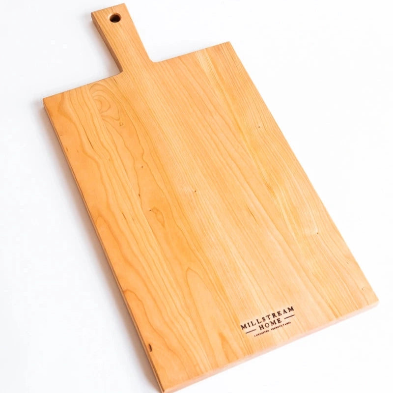 Wooden cutting board with handle on a white background